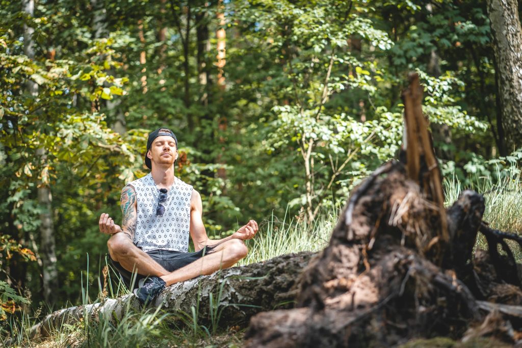 Man meditating in a forest.